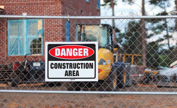 Danger Construction Area Sign On A Chain Link Fence